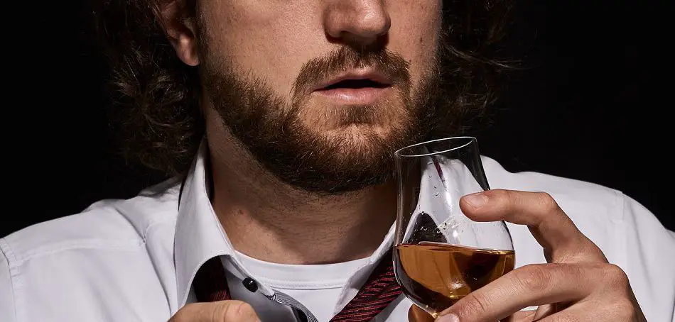 Man smelling a glass of whiskey