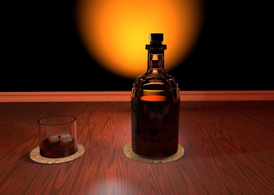 The sun behind a bottle of whiskey