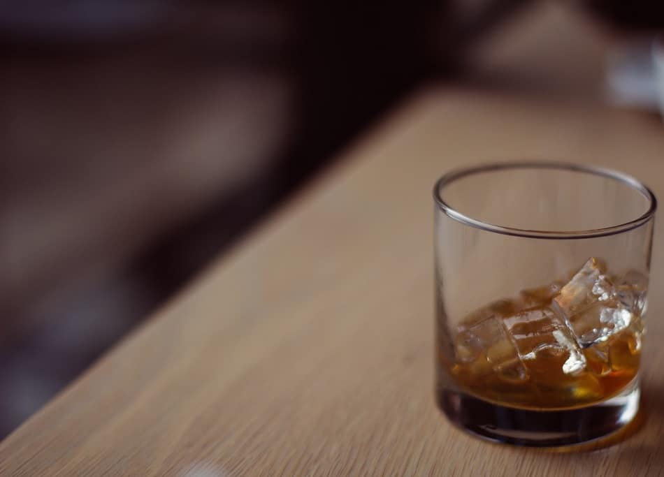 A glass of whiskey with ice