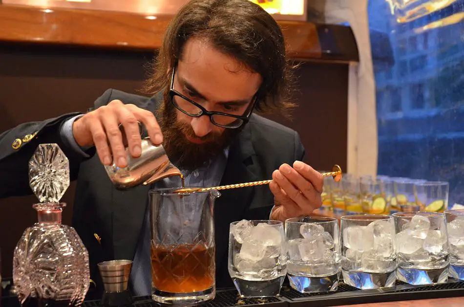 A man mixing whiskey