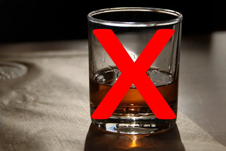 Glass of whiskey with a red X