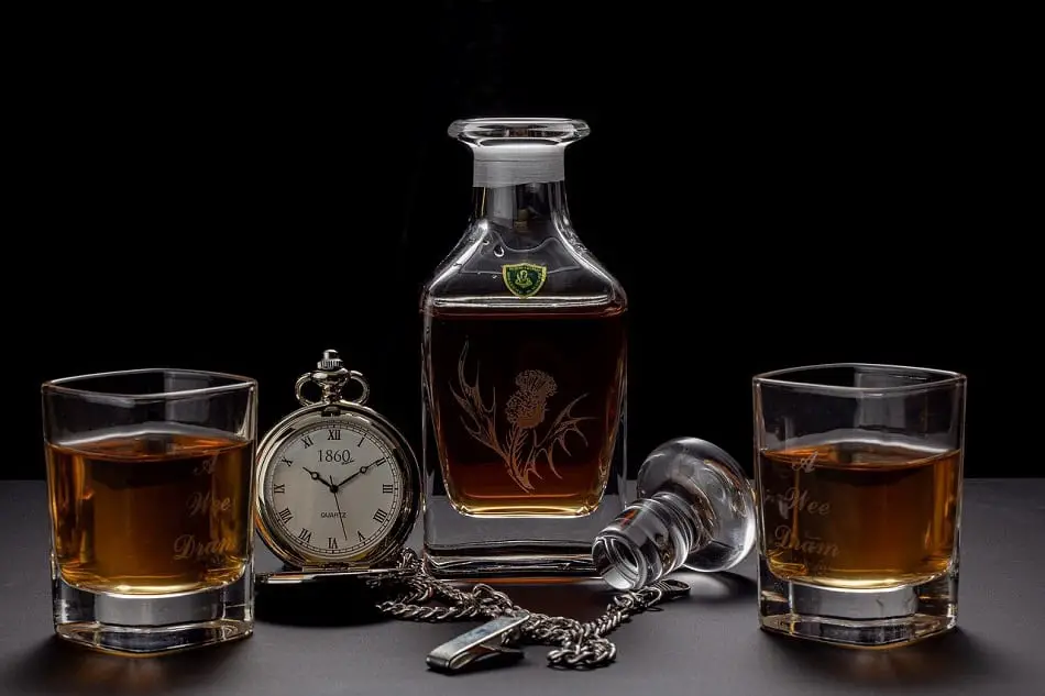 Whiskey glasses, decanter and clock