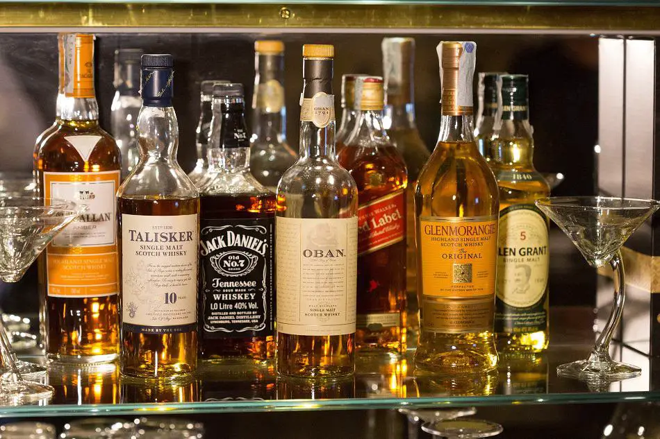 A collection of bottles of whiskey on a shelf