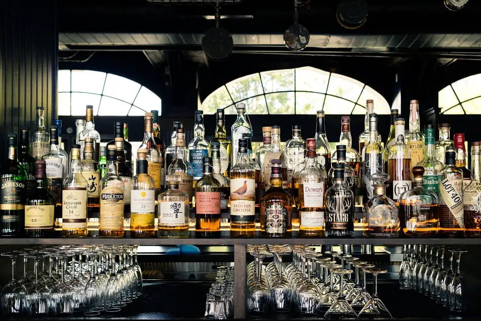 Lots of different whiskeys lined up in a bar