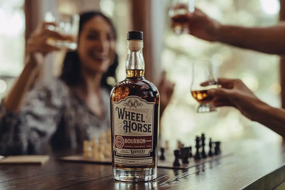 Three people enjoying a drink of whiskey