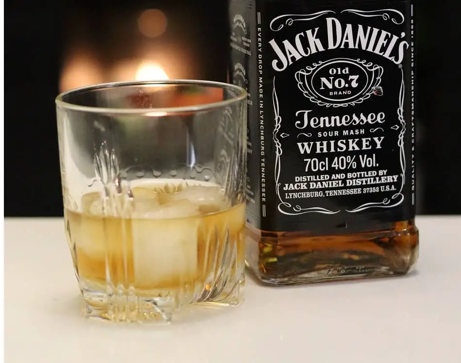 Bottle of Jack Daniel’s and glass of whiskey with 3 ice cubes – Frank’s way