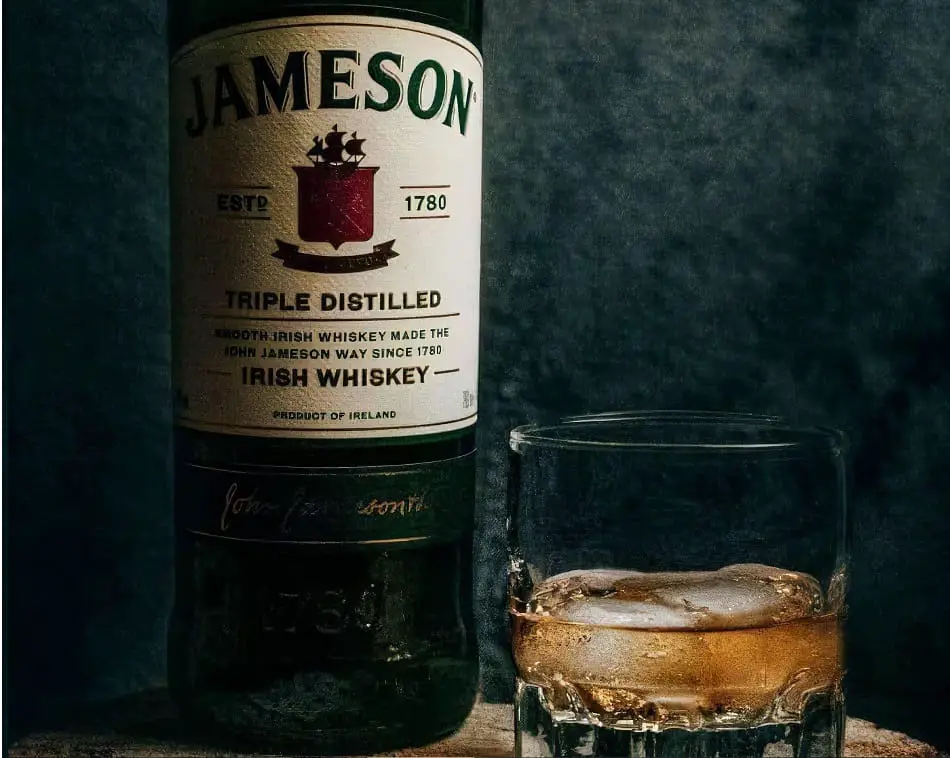 Bottle of Jameson Irish Whiskey and a glass of whiskey with ice