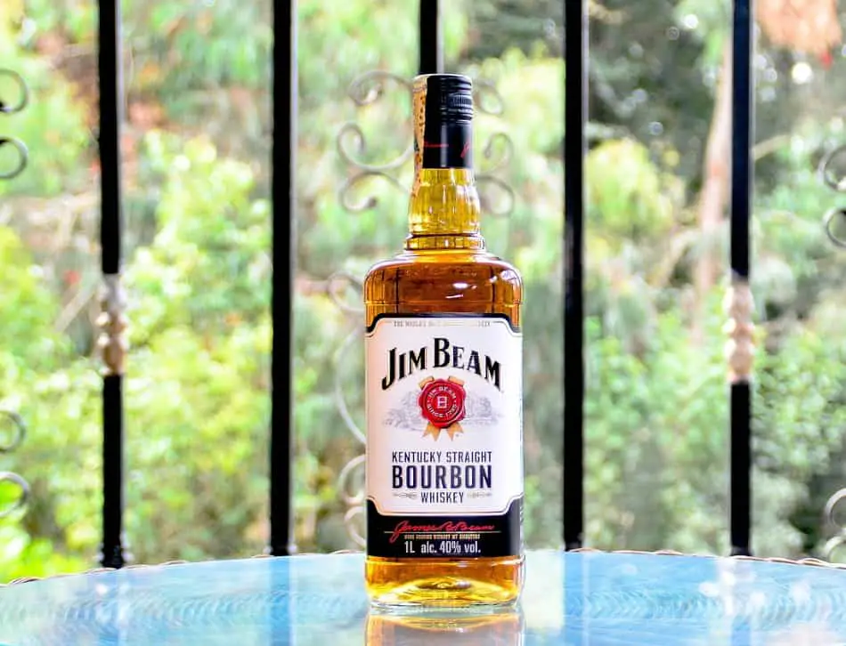A bottle of Jim Beam on a garden table