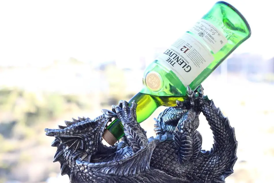 Statue of a dragon drinking a bottle of Glenlivet 12
