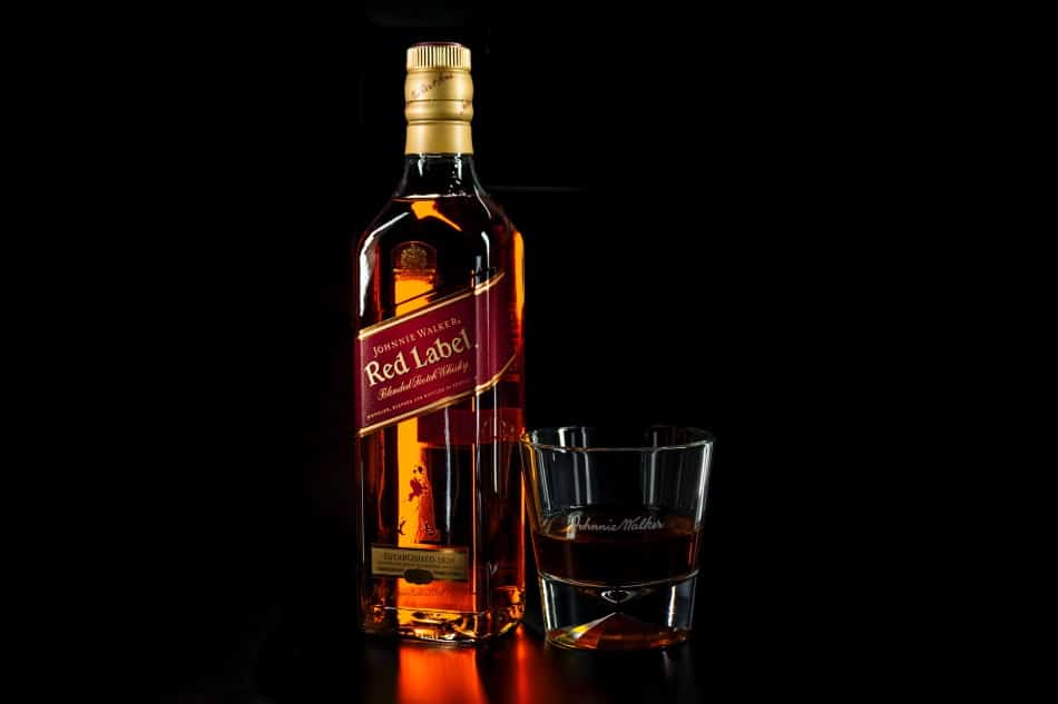 A bottle of Johnny Walker Red Label and a glass of whisky