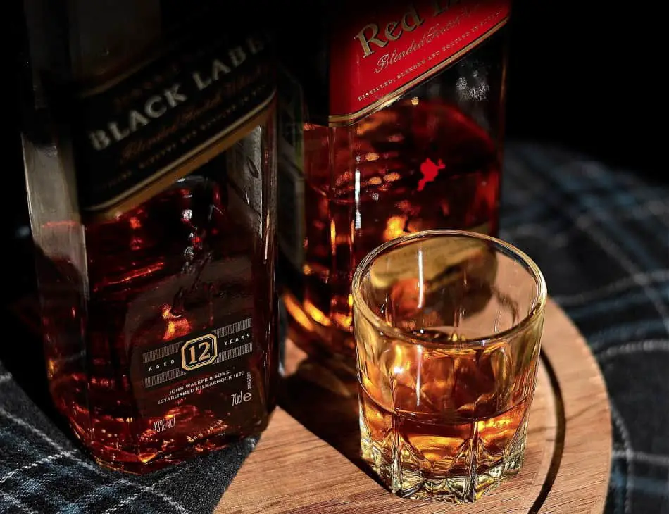 Johnny Walker Black Label and Red Label with a glass of whisky