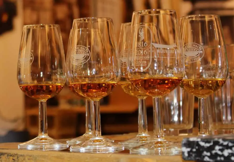 6 nosing glasses with small amounts of whiskey inside