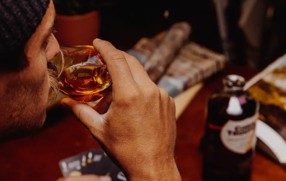 A man tasting his whiskey