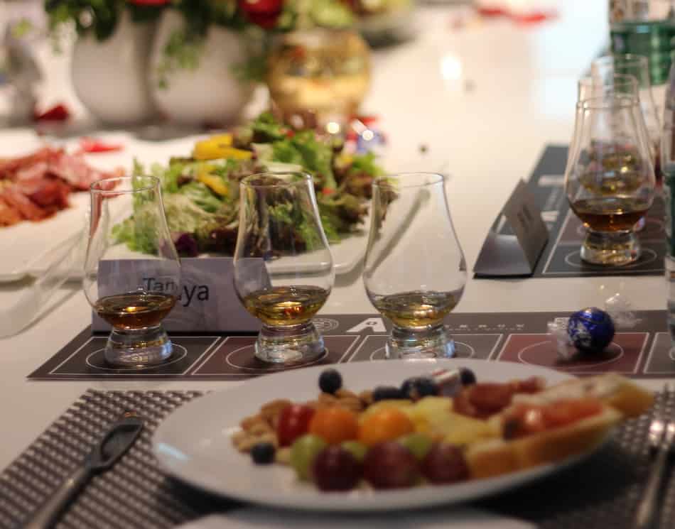 Plates of food and drink at a whiskey tasting