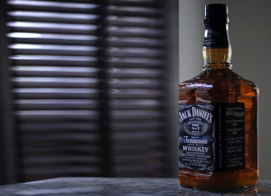 A bottle of Jack Daniel’s in front of shutters that are protecting it from the sunlight
