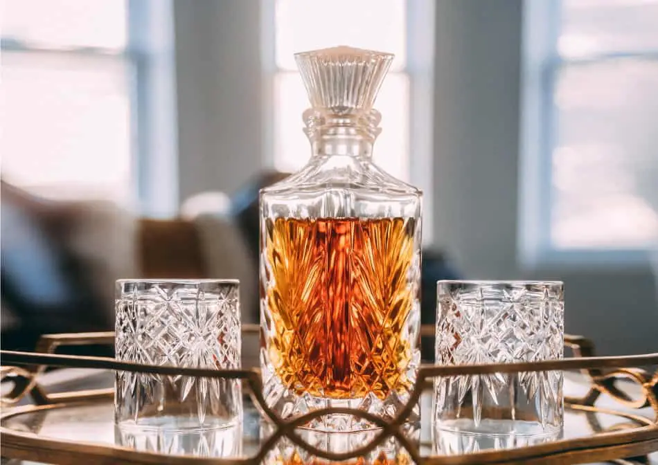 A whiskey decanter and two glasses