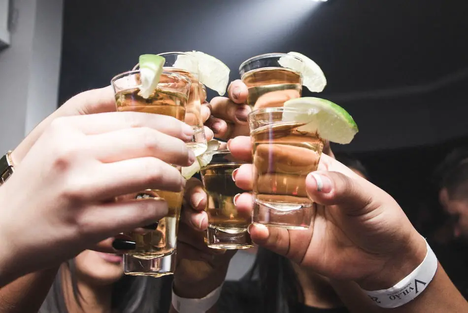 Whiskey shot glasses being held by the body