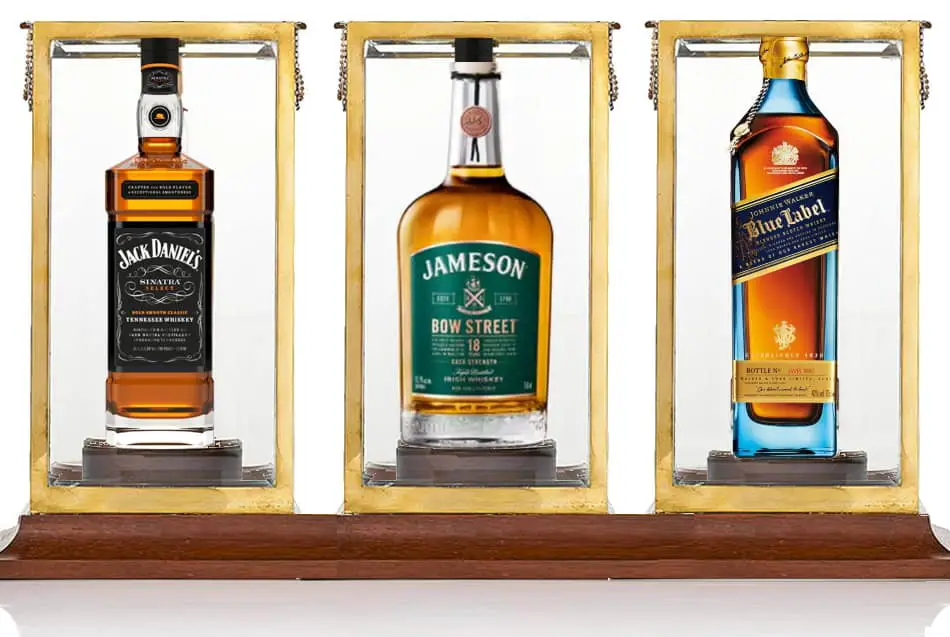 Bottles of whiskey in a glass box with ultra violet coating