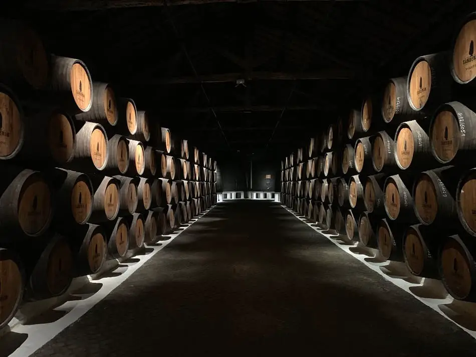 Whiskey being aged in barrels in a warehouse