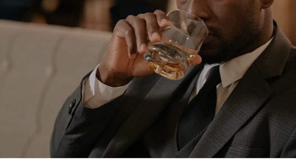 A man drinking bourbon