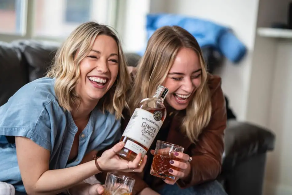 Friends bonding over a bottle of bourbon